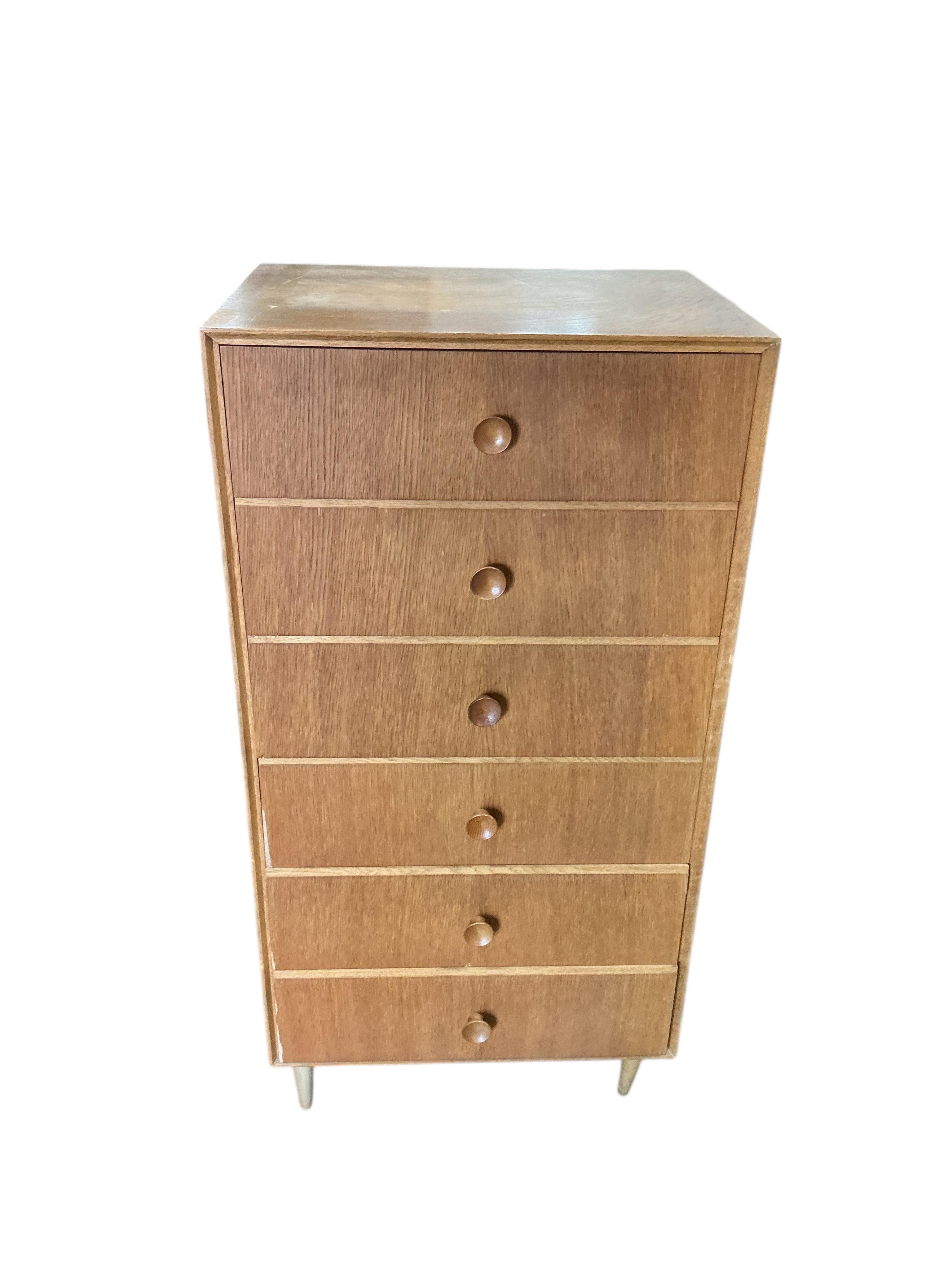 A mid century oak six drawer chest, width 61cm, depth 46cm, height 124cm